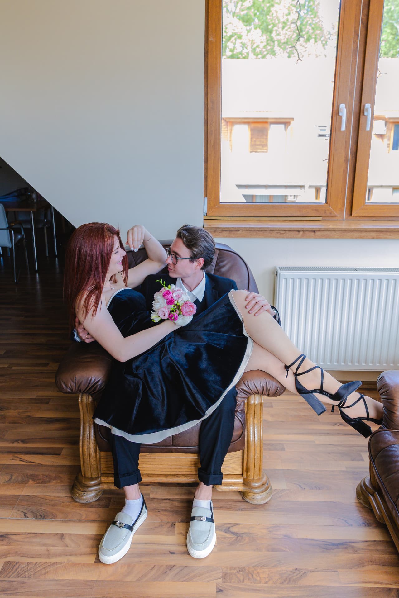 Newly engaged couple in black formalwear relaxing together after their Budapest proposal