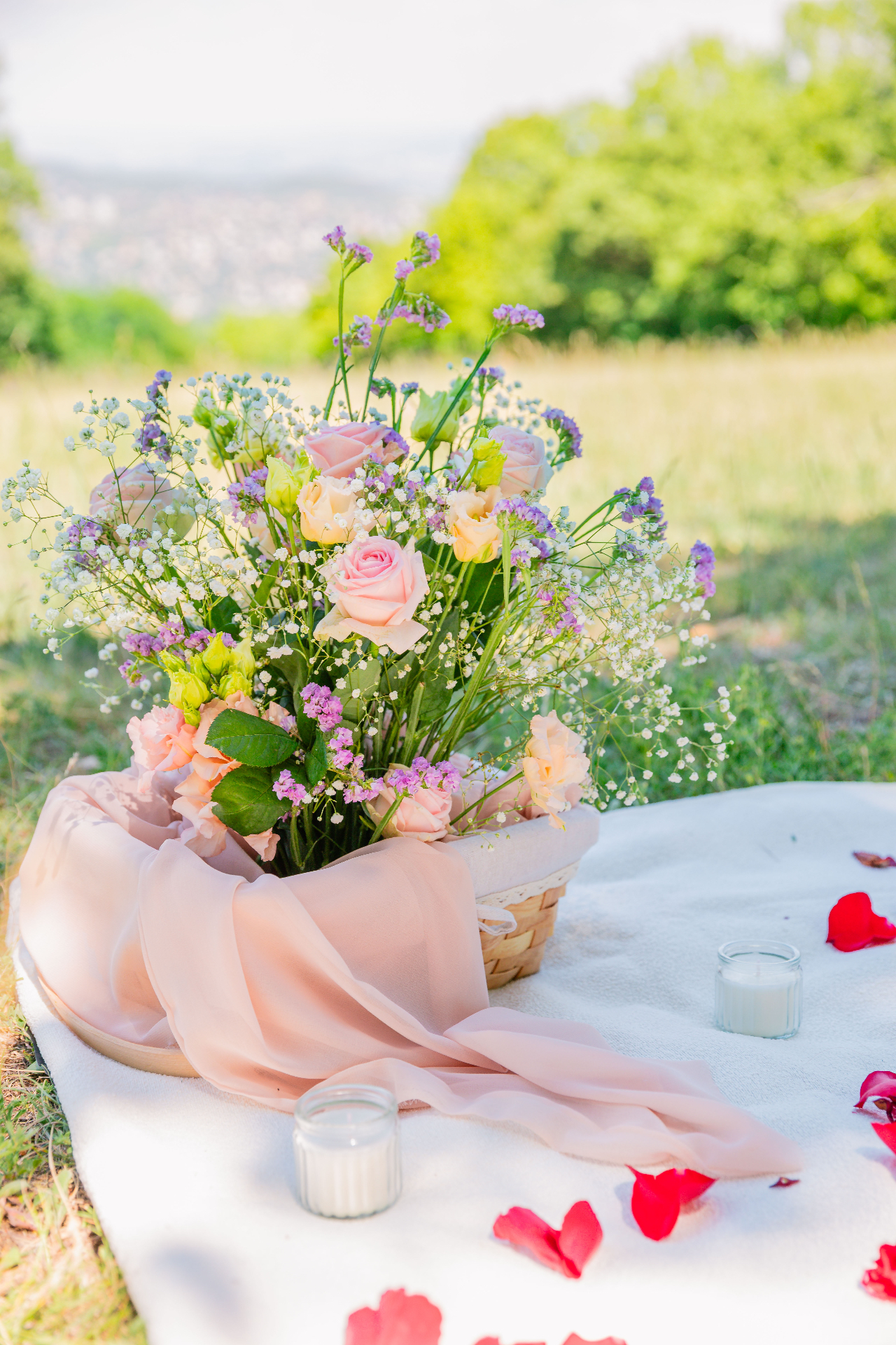 Pastel rose and baby's breath bouquet in a basket on a hilltop with Budapest view — Vivielle Events florals