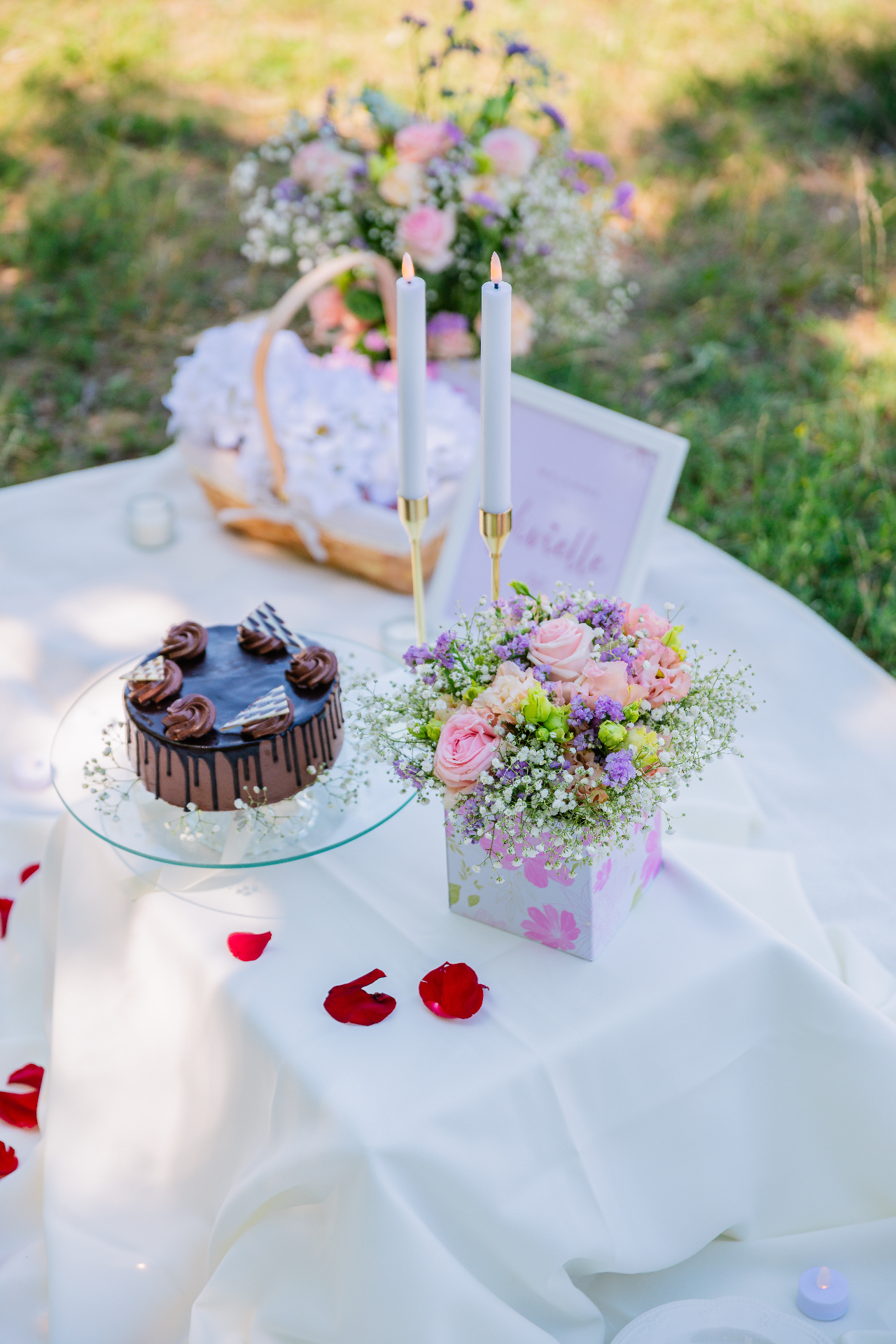 Elegant proposal tablescape with chocolate drip cake, pastel floral bouquet and taper candles — Vivielle Events Budapest