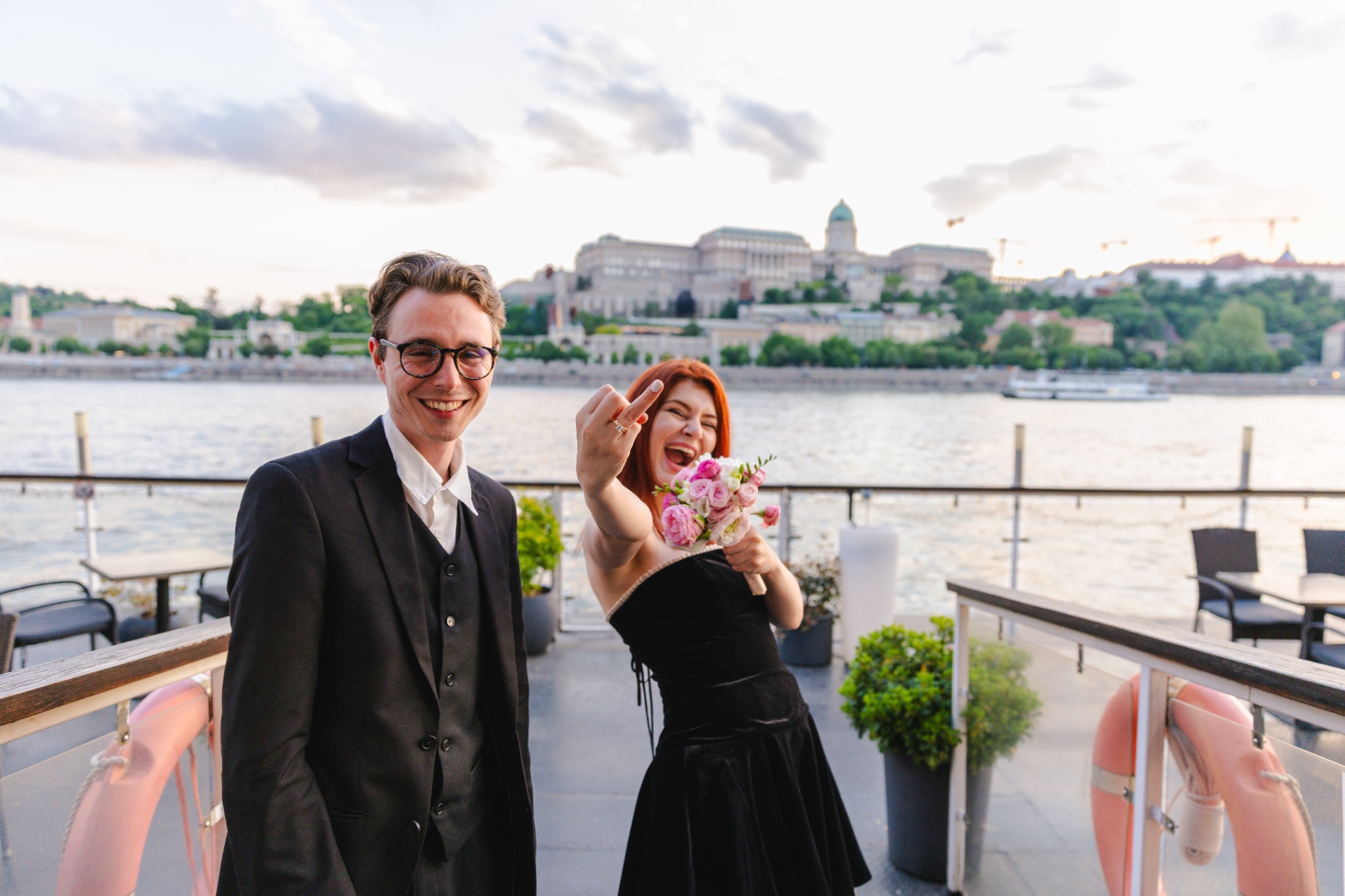 Newly engaged couple celebrating with Buda Castle behind them