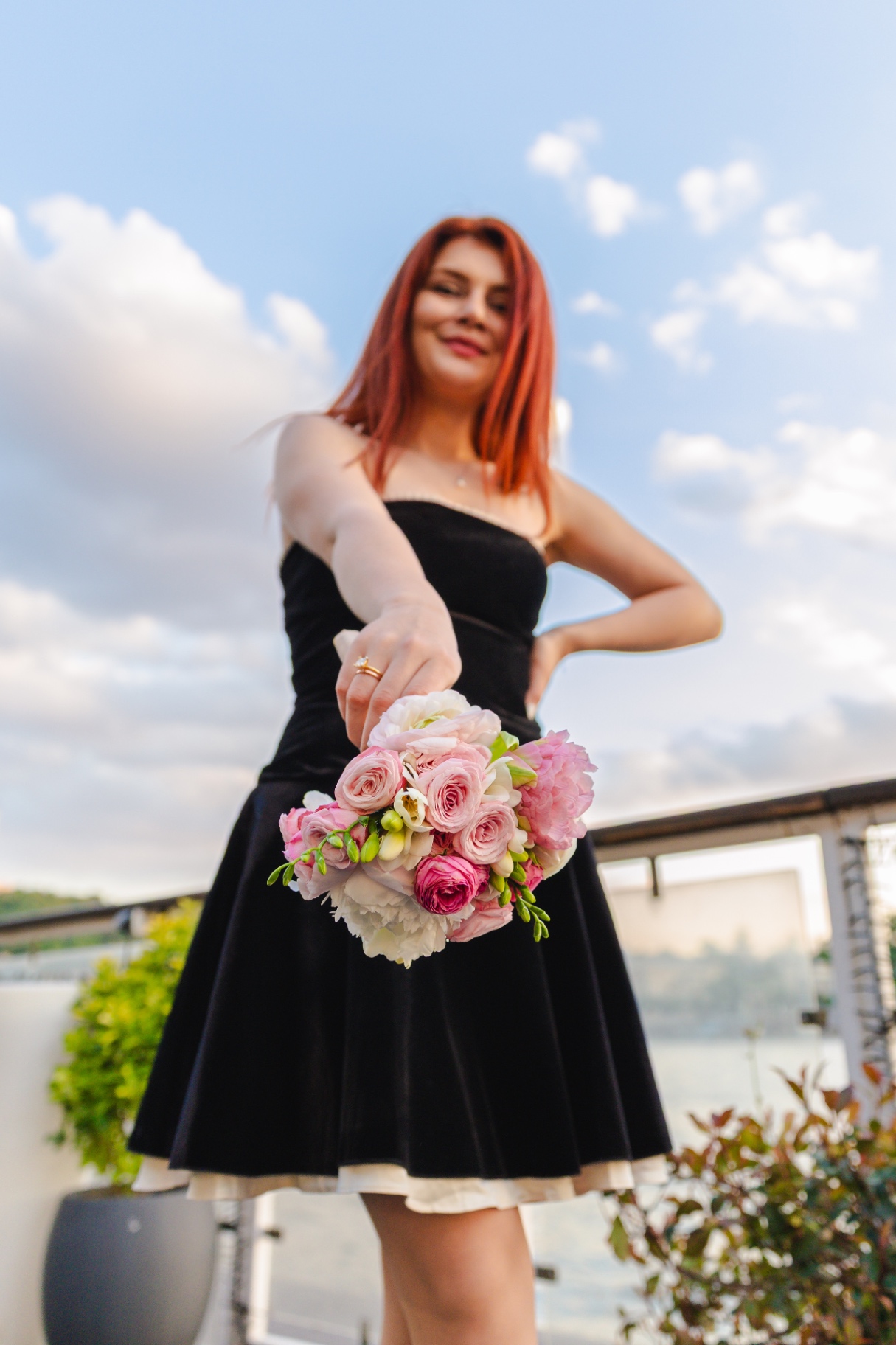 Bride in black velvet dress holding pink bouquet