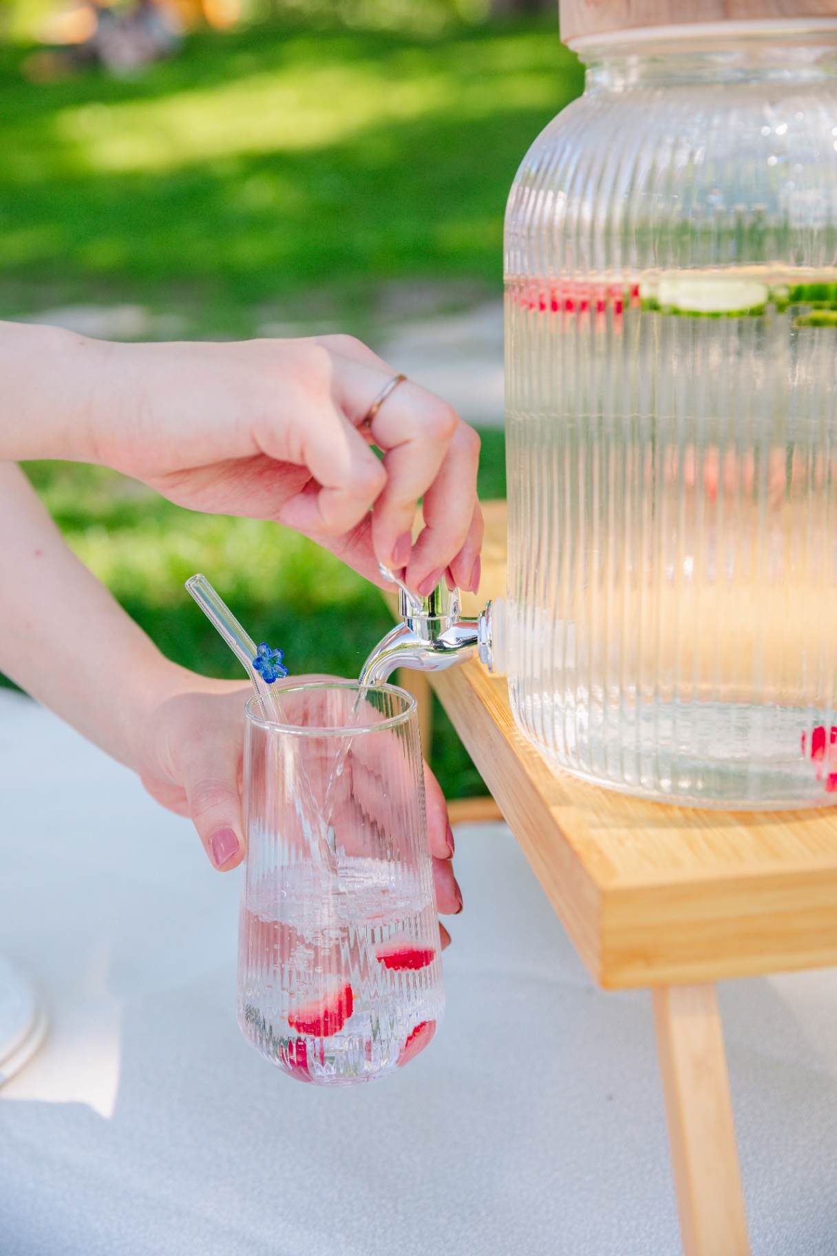 Luxury picnic Budapest refreshments — glass dispenser pouring infused water into a fluted glass