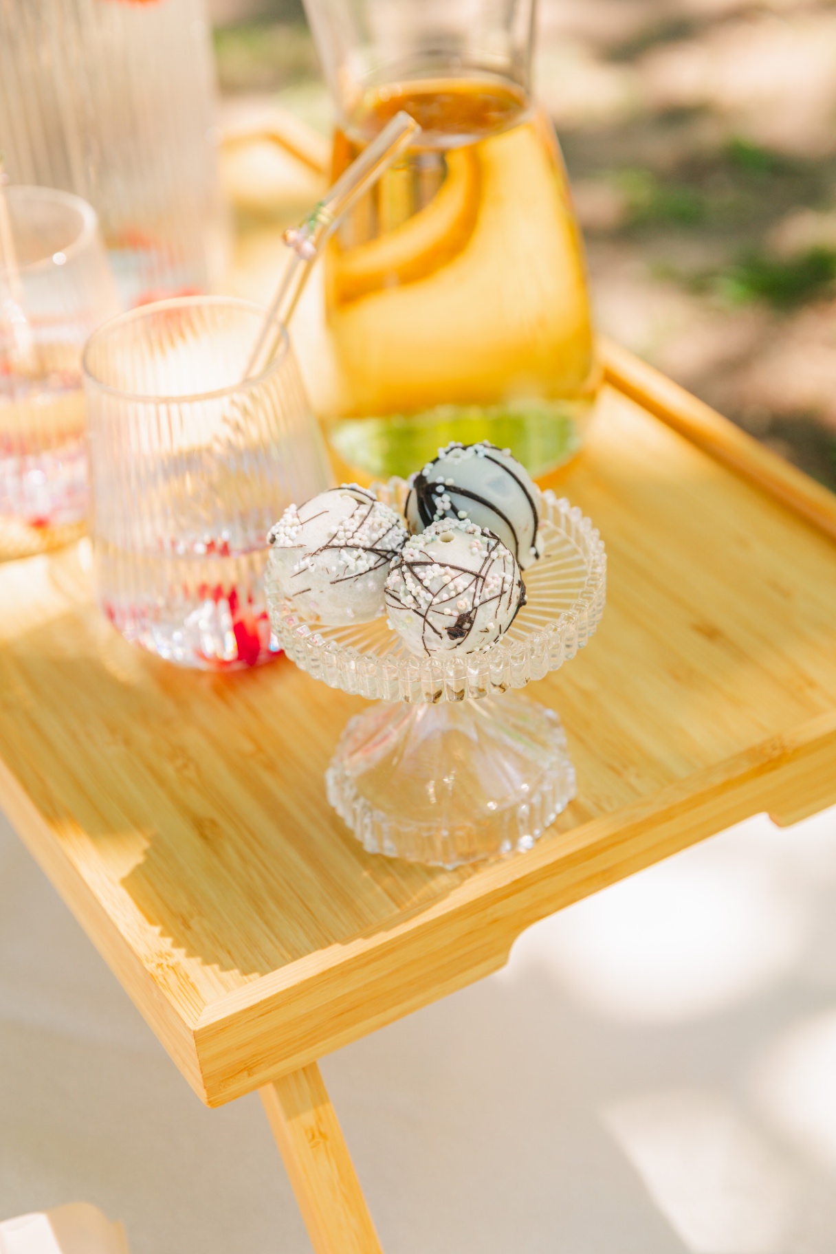 Premium event styling Budapest — coconut truffles on crystal stand with amber pitcher