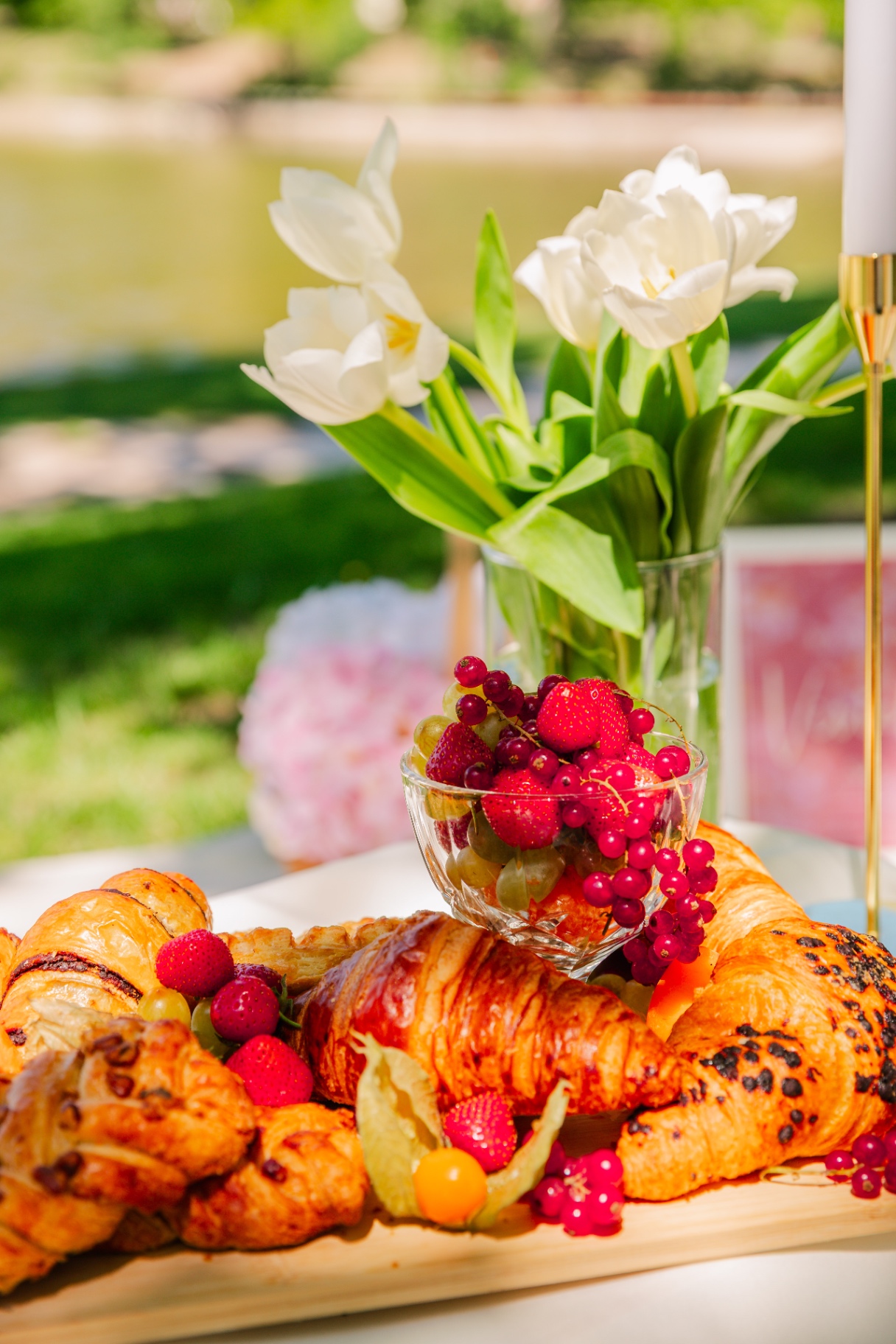 Premium milestone event styling Budapest — white tulips, fruit cup and croissant platter